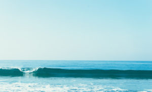 One small wave, calm sea, blue sky